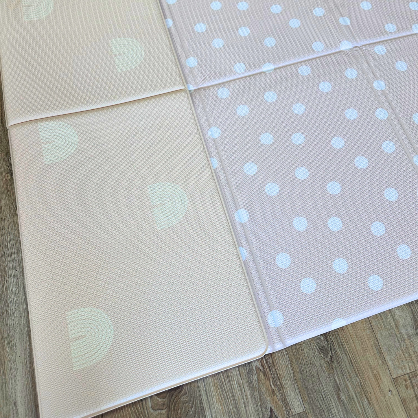 Plush Playmats Foldable Playmat with Rainbow & Dots designs. Shown partially folded.