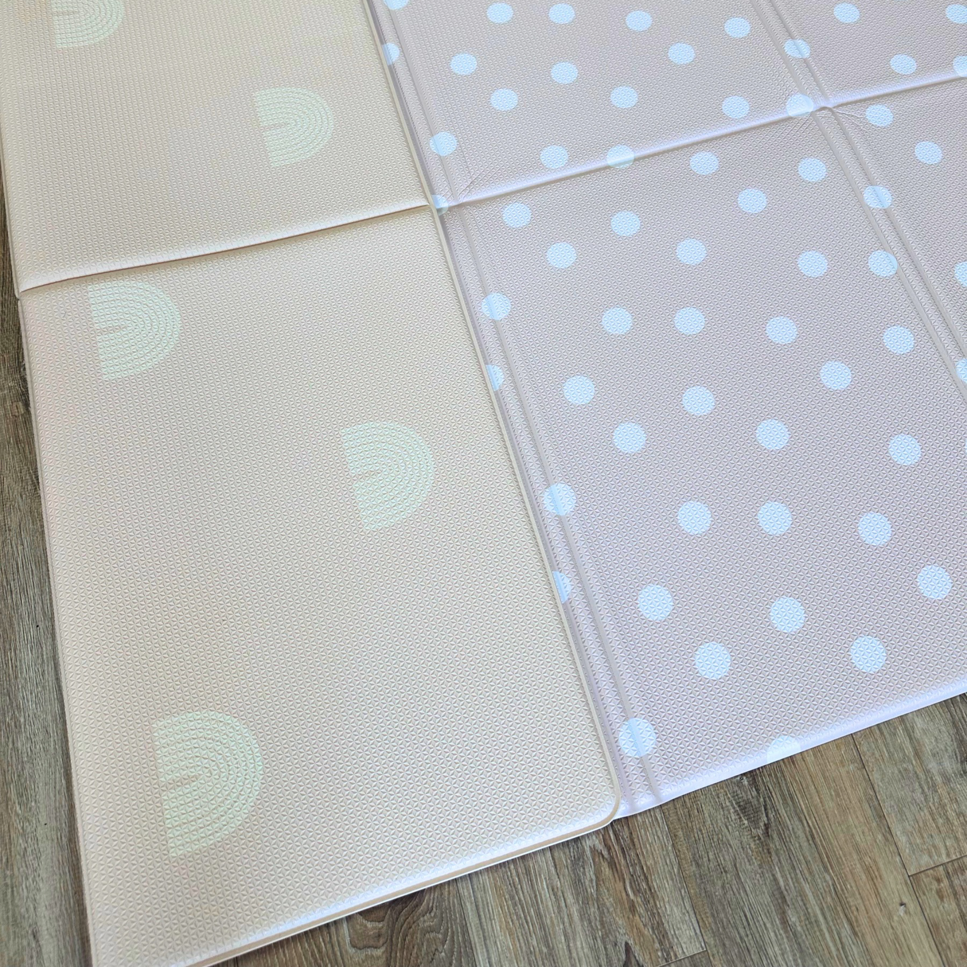 Plush Playmats Foldable Playmat with Rainbow & Dots designs. Shown partially folded.